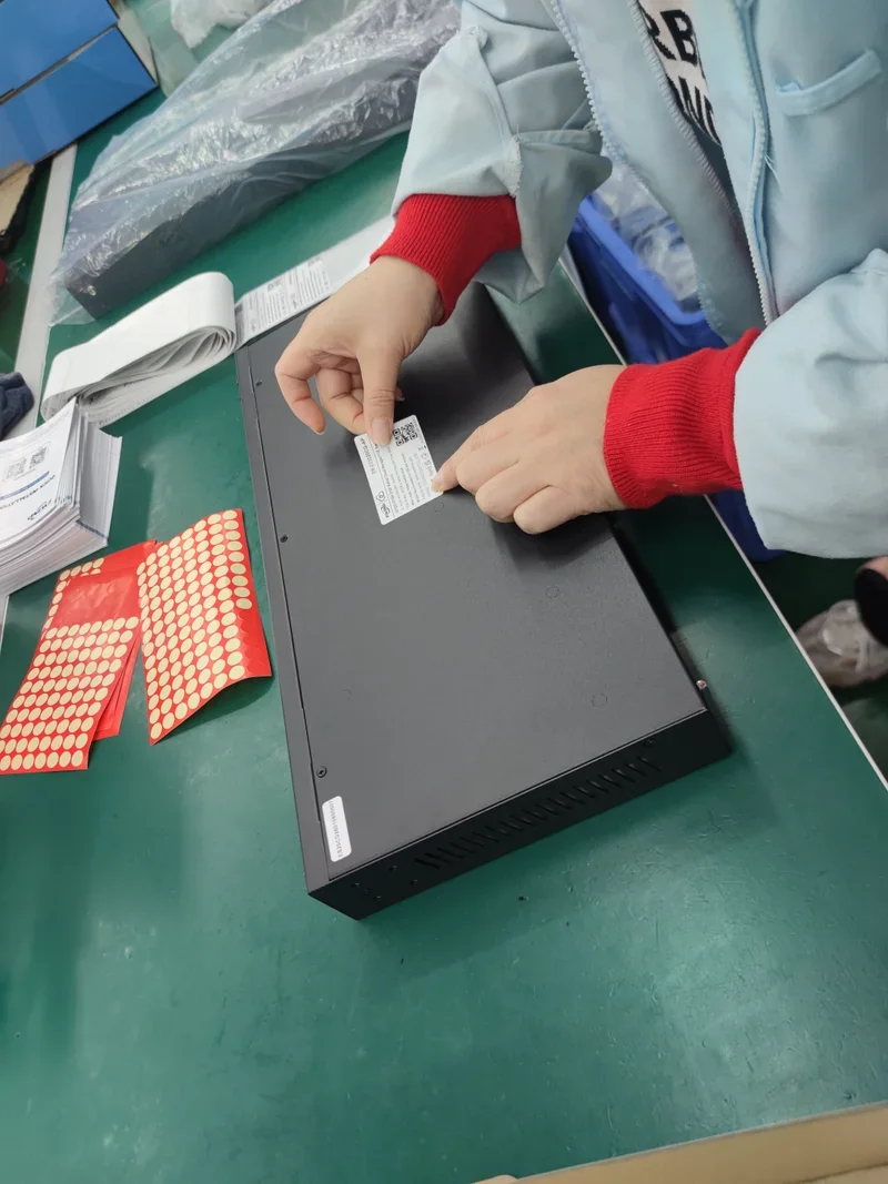 Operator applying a device label to a network switch